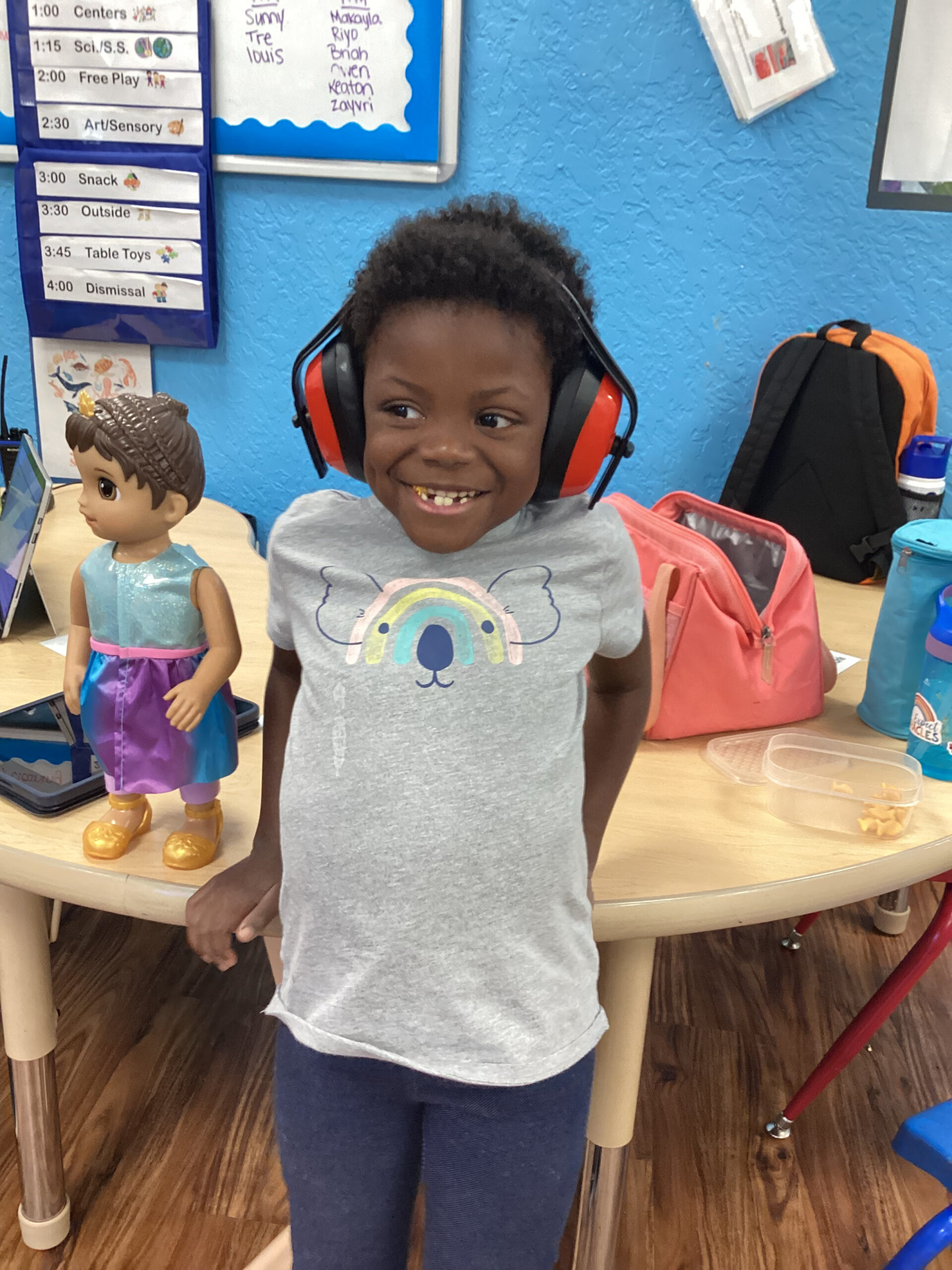 A student in a classroom wearing headphones, part of the Voluntary Pre-Kindergarten program.