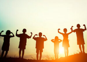 Group of children having fun during sunset.