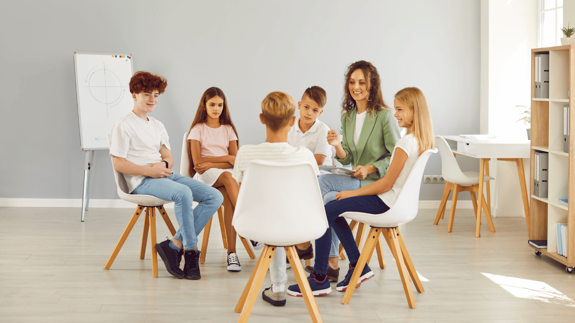 Young individuals of various backgrounds gathered at a table, symbolizing Social Communications