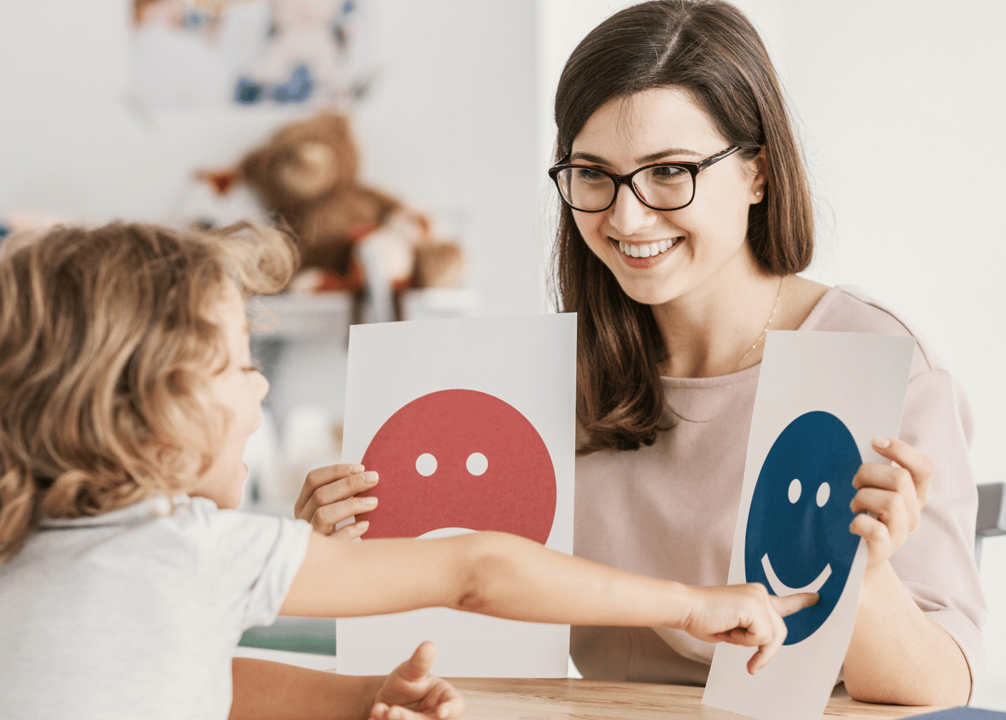 Woman and child displaying smiley faces, reflecting happiness and positivity.