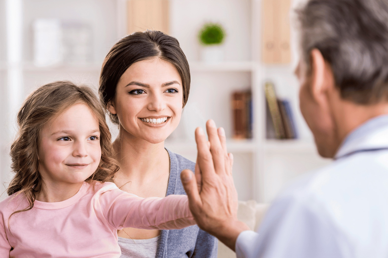 A woman and a little girl sitting and discussing autism.